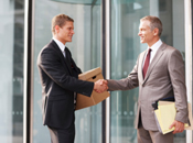 Man with box shaking hand