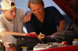 father and son fixing engine car